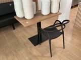 a black chair sitting in front of a table with plates on it