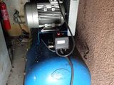 a blue air compressor sitting on top of a blue ball