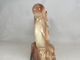 a small figurine of a man sitting on a table