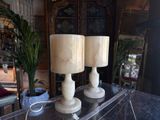 two lamps that are sitting on a table in a room