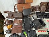 many different types of leather bags on a table