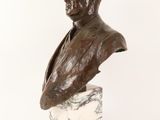 a close up of a bust of a man on a marble base