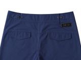 a close up of a blue shorts with a logo on the front