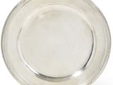 a silver plate on a stand on a white background