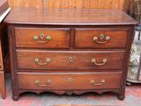 a wooden dresser with many drawers on it in a room