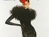 the cover of a magazine with a woman in a black dress and a red hat