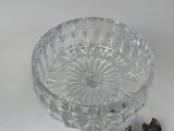 a glass bowl with a spoon and spoon rest on a table