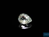 a close up of a white diamond on a black surface