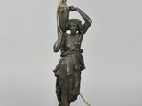 an image of a bronze statue of a woman holding a lamp