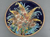 a decorative plate with a bouquet of flowers on it