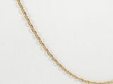 a close up of a gold chain on a white background
