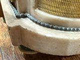 a close up of a clock with a chain on it