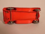 a red toy train car that is on a table