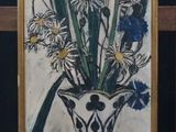 a picture of a painting of flowers in a vase on a easel