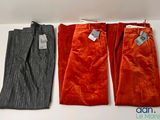 three pairs of pants are lined up on a shelf