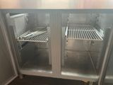 two open refrigerators in a kitchen with one door open