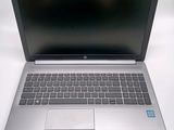 an open laptop computer sitting on top of a white table