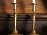 three candles that are sitting on a shelf