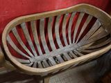 a wooden bench in a room with a red wall