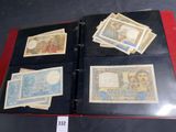 several different types of paper money are on display in a binder
