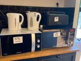 two microwaves sitting on top of a kitchen counter