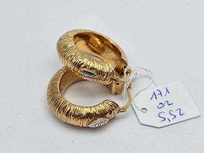 a close up of a pair of gold rings with a price tag
