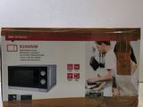 packaging of a microwave sitting on top of a white counter