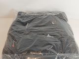 a bag of clothing wrapped in plastic on a table