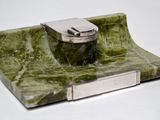 a green marble sink with a metal faucet on it