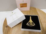 a bottle of perfume sitting on a table next to a box