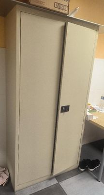 a tall cabinet in the corner of a room