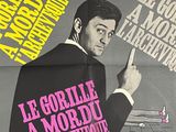 french movie poster of a man in a tuxedo pointing at a gun