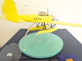 a yellow model of a small airplane on a table