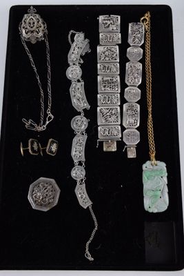 a black tray with a variety of jewelry on it