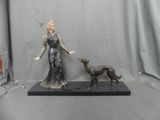 a statue of a woman and a dog on a table