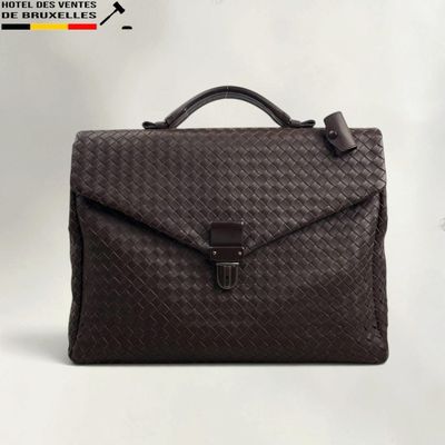 the brown briefcase is sitting on a white surface