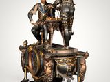 a statue of two men standing on top of a clock