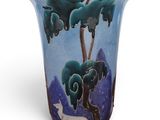 a vase with a picture of a dog and trees on it