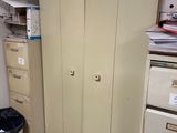 a cabinet in the corner of a room with many files on it
