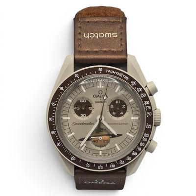 a close up of a watch on a white surface