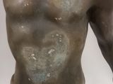 bronze statue of a man with no shirt and no shirt on