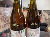 two bottles of wine sitting on a counter in a store