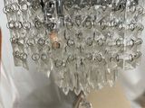 a glass chandelier hanging from the ceiling of a room
