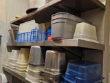 many pots and pans on the shelves in the kitchen