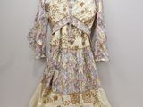 the dress is hanging on a hanger on the wall
