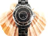 a picture of a black watch on a black bracelet