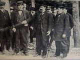 a group of men in suits and hats standing next to each other