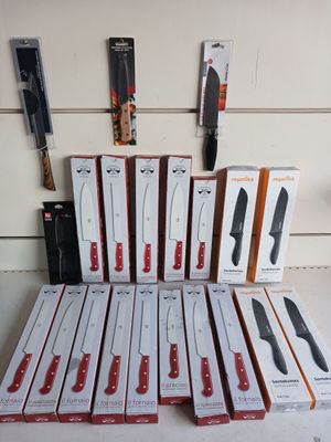 boxes of knives are stacked on top of each other on a table
