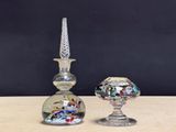 pair of glass candlesticks and a glass candle holder on a wooden table