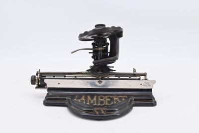 an old fashioned sewing machine on a white surface